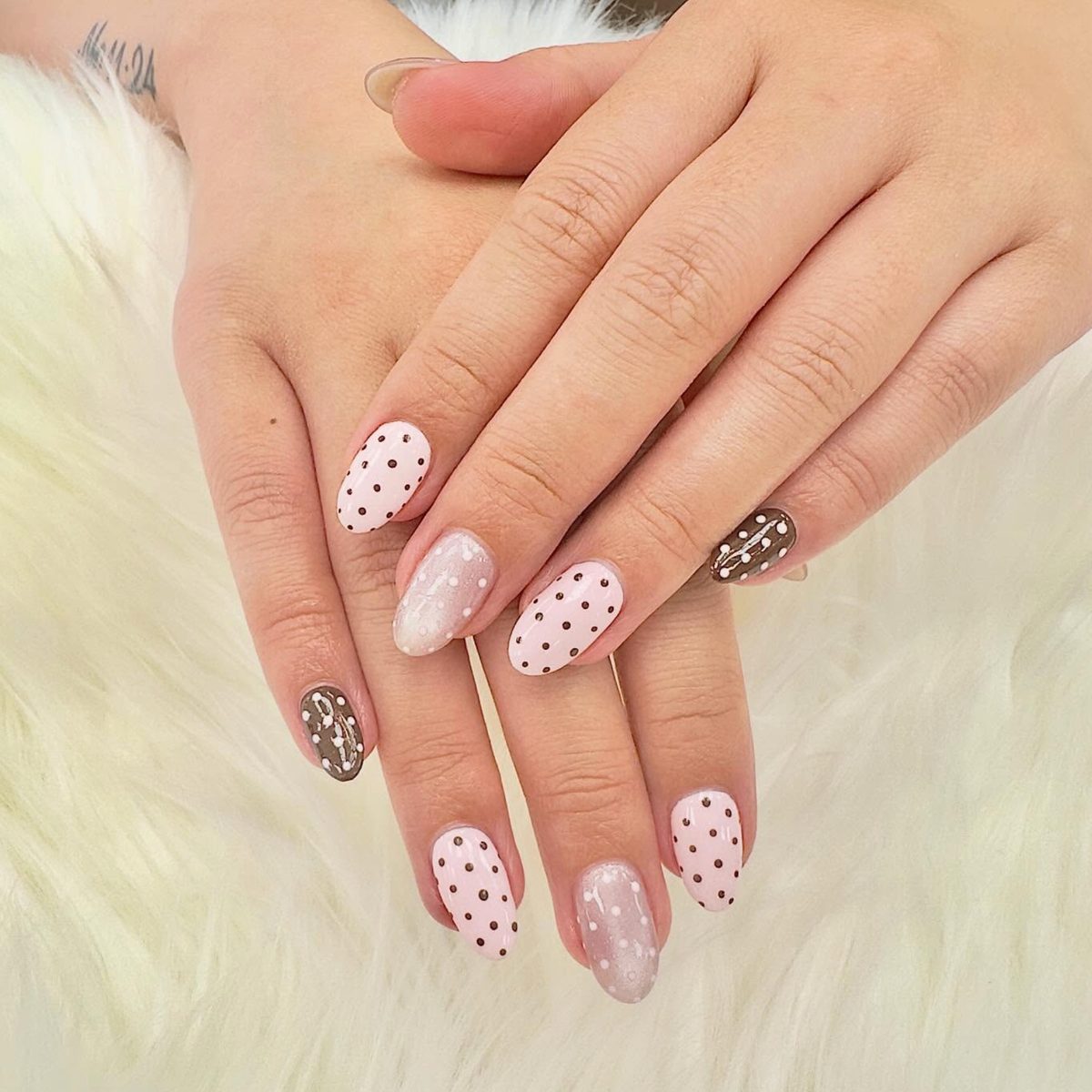 Blush pink nails with brown polka dots and donut art