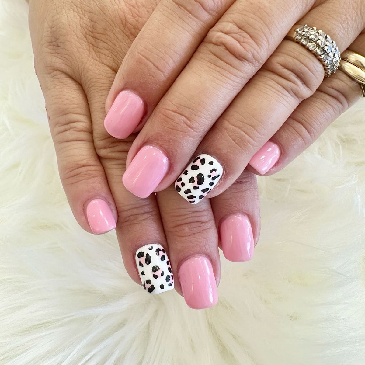 Soft pink nails with white leopard-print accent
